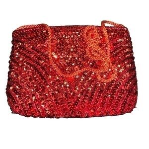 Add a touch of vintage glamour to your look with this beautiful red sequin clutc